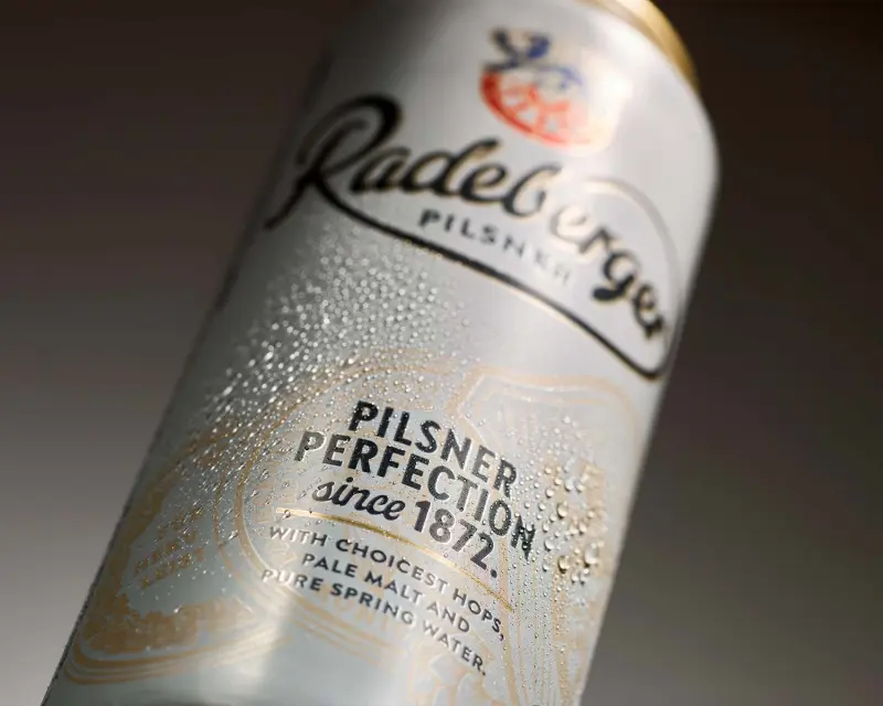 Close-up of a chilled Radeberger Pilsner can with condensation and a clearly visible brand label.